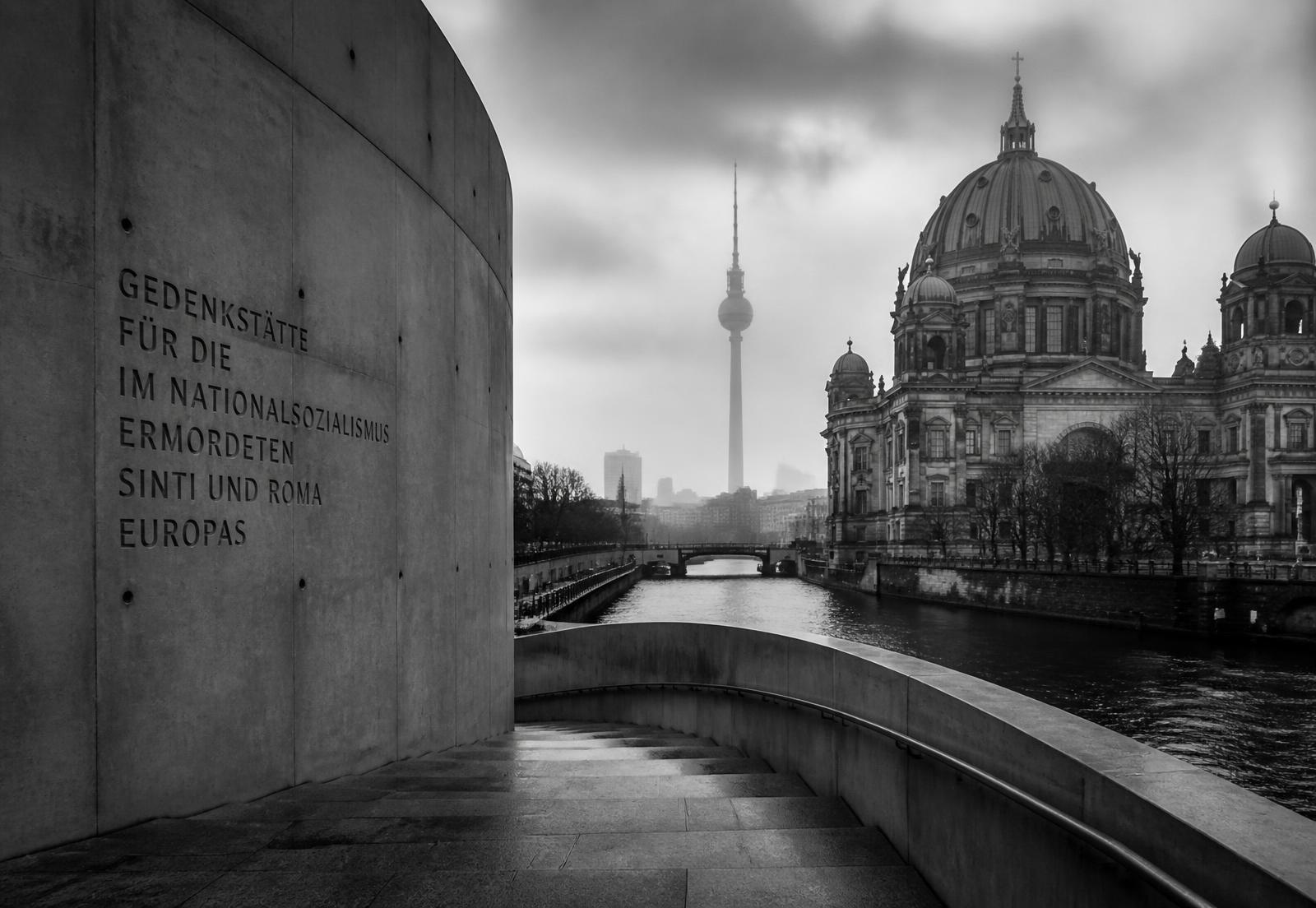 Berlin skyline with a memorial wall and stone staircase
